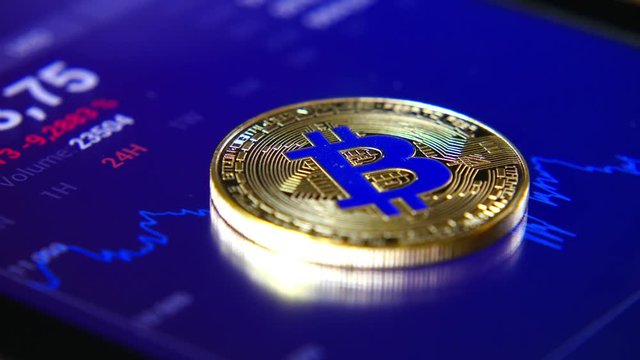 Golden bitcoins on the background of a graphic stock chart. The Concentration of the Crypto-Currency of Virtual Money