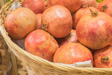 Pomegranate fruit  in the basket . Healthy eating concept.