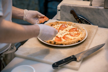 A process of preparing pizza by a chef