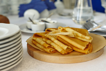 Russian pancakes on the table, laid for breakfast