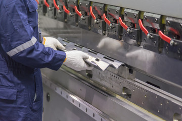 The technician operator use hydraulic bending machine. Metal working concept