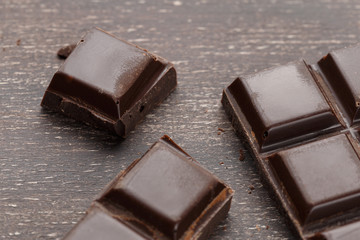 Dark chocolate bar on a wooden table