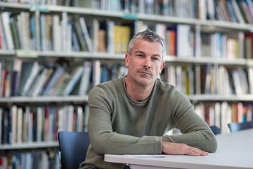 Portrait of mature student in college library