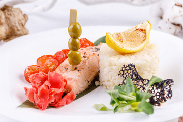 Original and appetizing salmon steak with a side dish of rice.