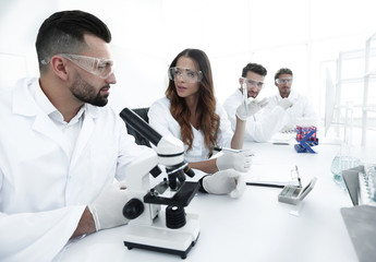 group of young scientists discussing the results of a study