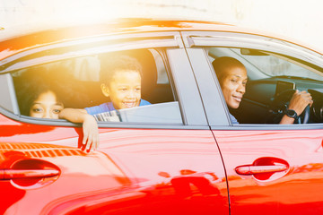 Happy and excited African American family taking a road trip with their car - Happy family togetherness concept - Powered by Adobe