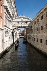 Fototapeta na wymiar Venice, Bridge of sighs with gondola. Characteristic little bridge that connect historical Ducal Palace with prison.