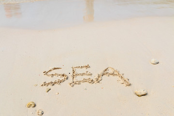 Word sea on sand.