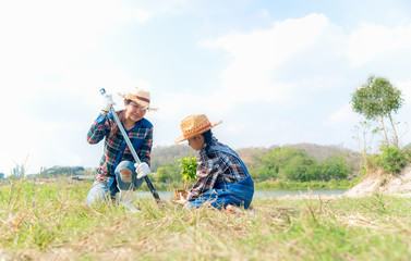 Asian family mom and child girl plant sapling tree in the nature spring for reduce global warming growth feature and take care nature earth.