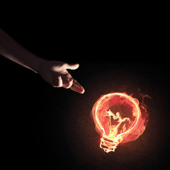 Concept of electricity or inspiration with burning light bulb an