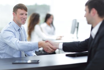 handshake business partners at your Desk
