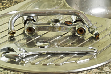 plumber changing old  faucet