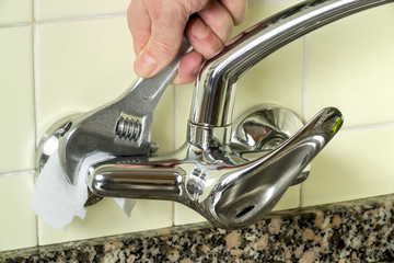 plumber installing new faucet