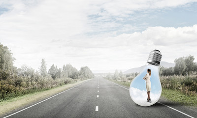 Businesswoman inside light bulb