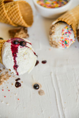 Ice-Cream Plombir In A Waffle Cup With A Topping Of Fresh Blueberries And Syrup, Grated Chocolate, Sprinkles, Overhead View.