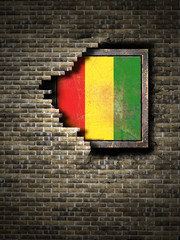 Old Guinea flag in brick wall