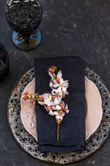 Spring table setting with blossoming almond branch