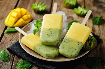 Kiwi mango ice cream with fruits and ices