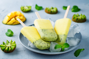 Kiwi mango ice cream with fruits and ices