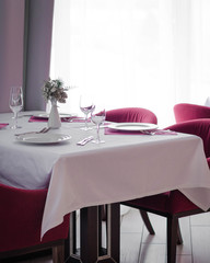 Served dinner table in a restaurant. Restaurant interior. Cozy restaurant table setting