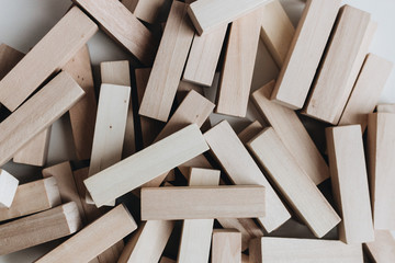 Pile of small wooden blocks for Jenga table game on white background
