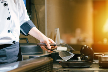 Hand of man take cooking of meat with vegetable grill, Chef cooking wagyu beef in Japanese teppanyaki restaurant