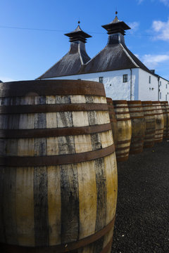  Traditional white painted building with black double tower roof of Scottish Whisky distillery