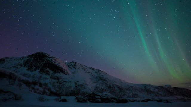 Time lapse clip of Polar Light or Northern Light (Aurora Borealis) in the night sky over the Lofoten islands in Northern Norway in winter.