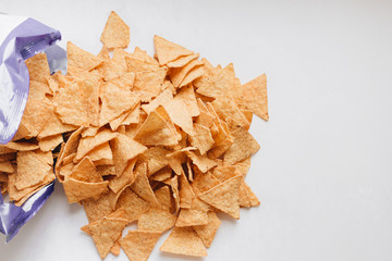 pile of delicious crispy nachos on white background, traditional Mexican cuisine