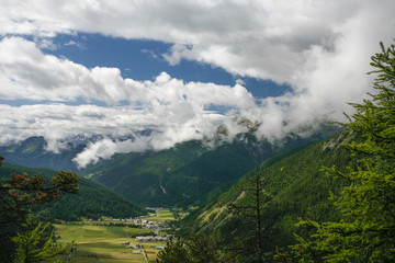 Mountain valley with the clouds in the summer time