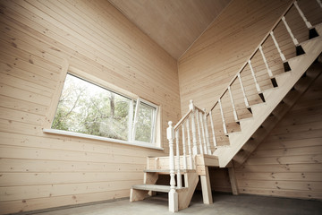 Empty room interior with wooden stairway