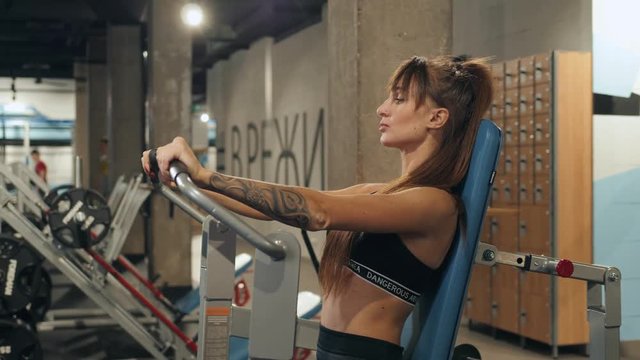 Sport. Beautiful woman in gym doing chest muscles training workout girl brunette athlete hard crossfit