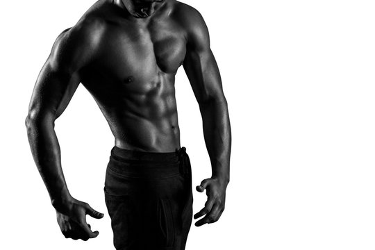 Highly retouched black and white fitness model and bodybuilder, Looking and posing abs and chest. concept of power and strength. Isolated on white background. Copy space.