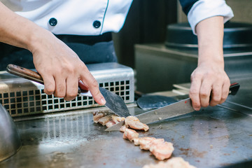 Hand of man take cooking of meat with vegetable grill, Chef cooking wagyu beef in Japanese teppanyaki restaurant