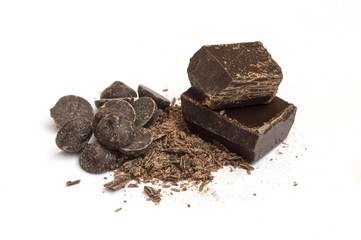 piece of dark chocolate with chocolate chips and droplets on white background