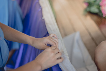 Close-up to Student hands are decorating the curtains..Decorate the stage