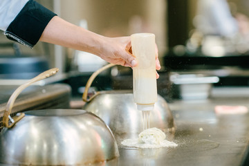 Hand of man take cooking of meat with vegetable grill, Chef cooking wagyu beef in Japanese teppanyaki restaurant