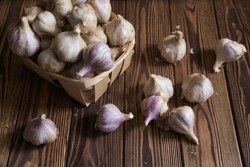 Bulbs of garlic on wooden background