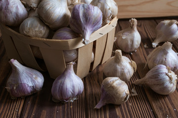 Bulbs of garlic on wooden background