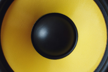 Subwoofer dynamic membrane or sound speaker as music background, yellow Hi-Fi loudspeaker close up