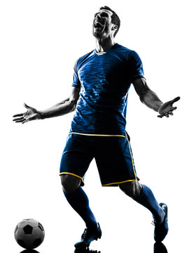 Fototapeta one caucasian soccer player man happy celebration  in silhouette isolated on white background