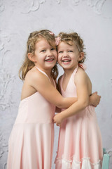 Happy Sisters in Pink Dresses Smiling Girls