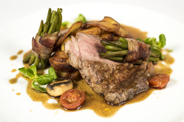 Steak chicken breast olive oil cherry tomatoes pepper and rosemary herbs.