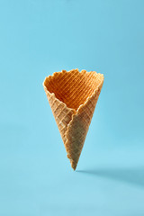 Waffle cornet on light blue background.