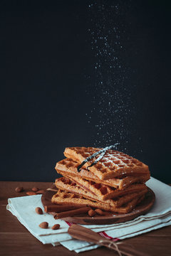Sweet potato waffles stacked on wooden plate
