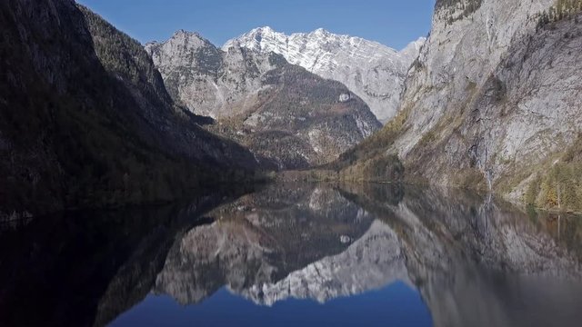 Flight over calm Obersee Lake in the Berchtesgaden National Park, Bavaria, Germany.
