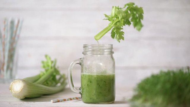 Cinemagraph - Pouring the celery juice into a glass. Nobody. Motion Photo.