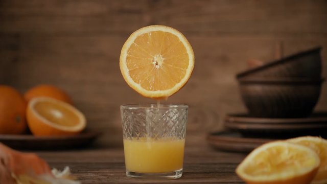 Cinemagraph - Pouring the orange juice into a glass. Nobody. Motion Photo.