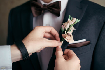 Close-up of the the groom boutonniere, butterfly, wedding handkerchief in the pocket	