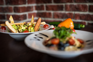 Pasta with vegetables on plate, traditional Italian food, pasta, tomatoes, rucola